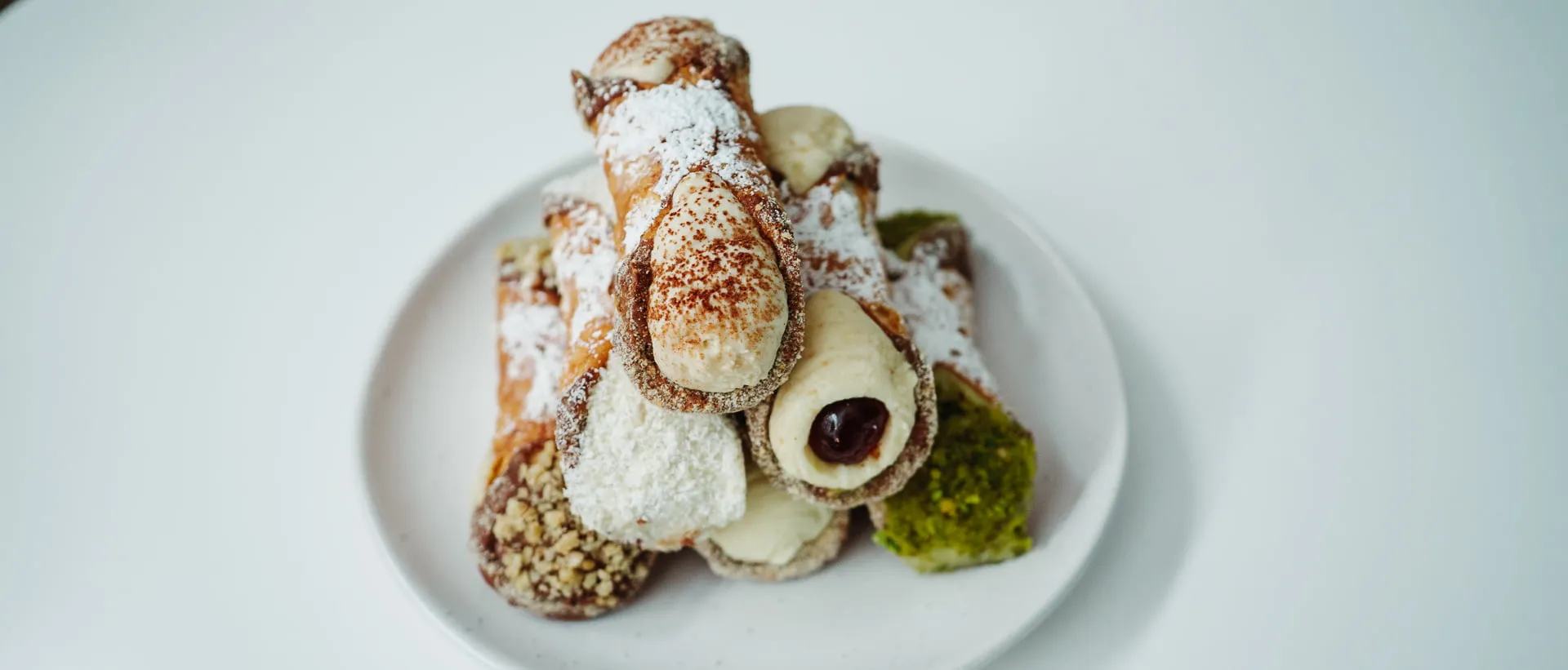 A plate of delicious cannoli, one of Perth's best Italian sweet treats.